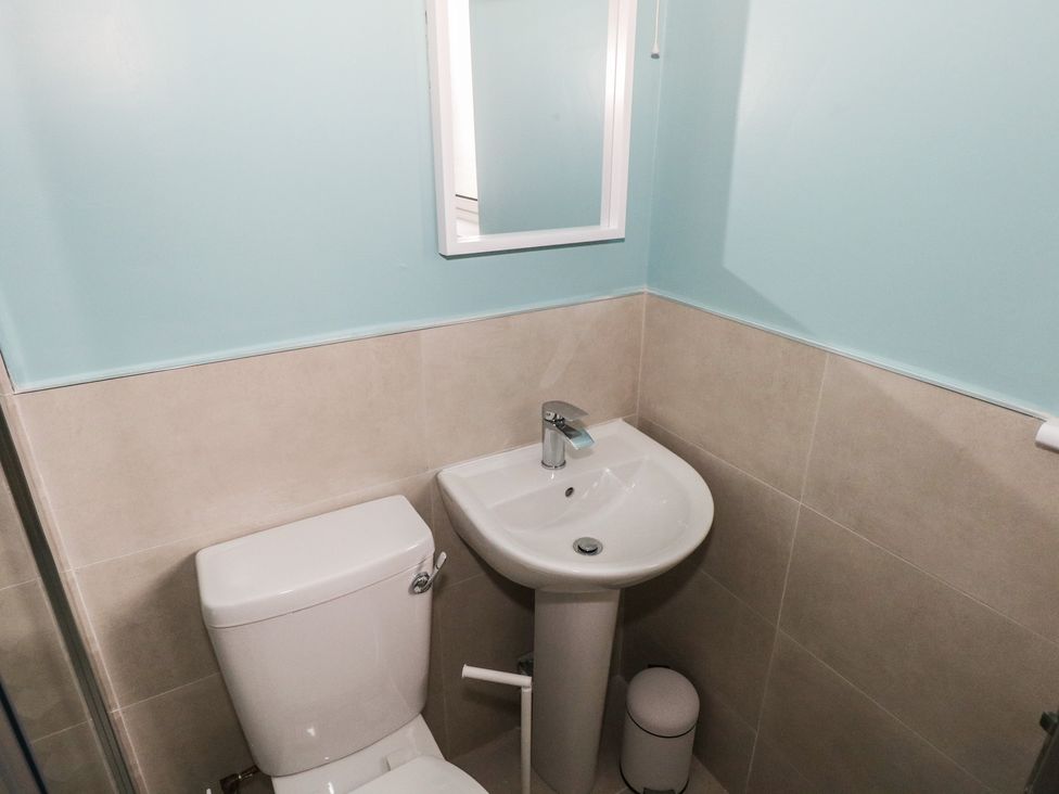A bathroom with a toilet and sink at No.3 Beach Cottages in Keel, County Mayo