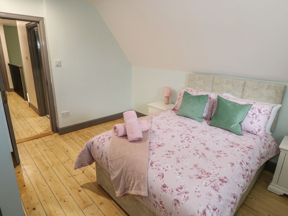 A bedroom with a bed and nightstand at No.3 Beach Cottages, Keel, County Mayo