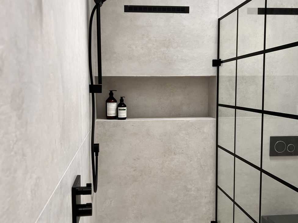 A shower area with shelves and soap at Wabi in Gembling near Beeford
