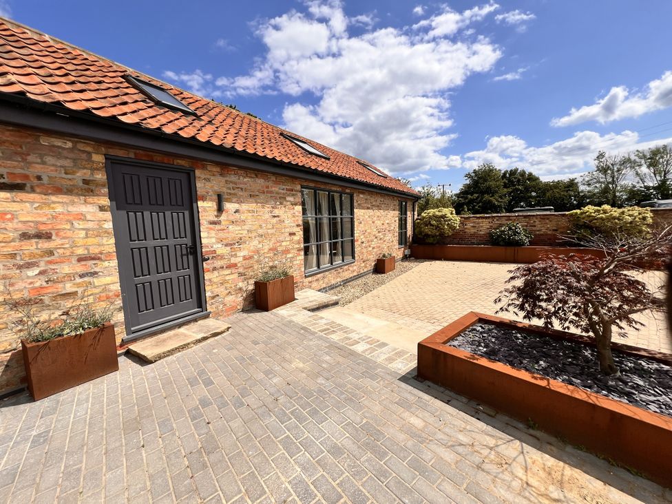 An outdoor area with a door and planters at Sabi in Gembling near Beeford
