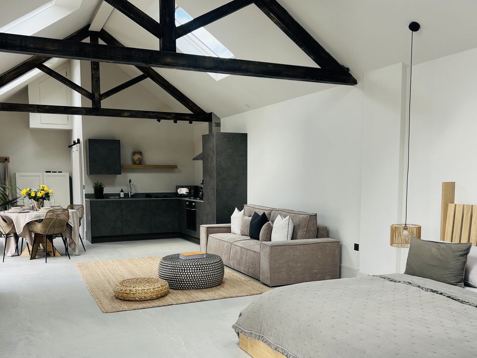 A living room with a sofa and dining area at Sabi in Gembling near Beeford