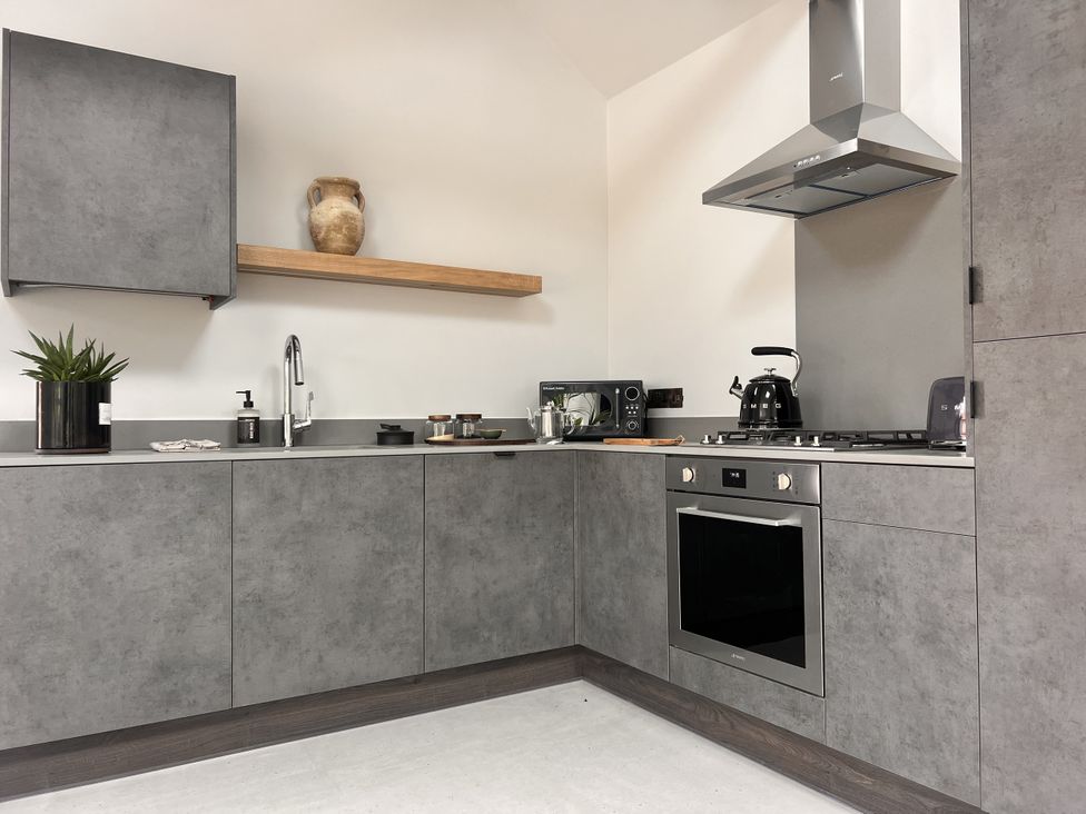 A kitchen with cabinets and appliances at Sabi in Gembling near Beeford