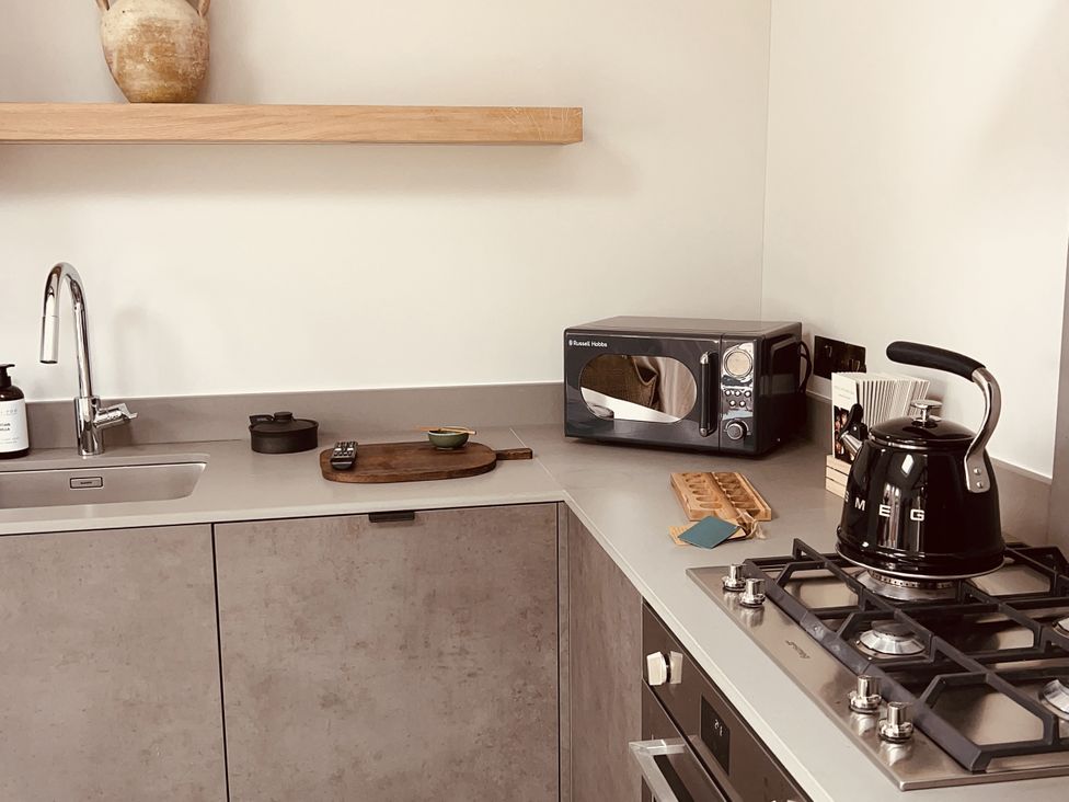 A kitchen with a kettle, sink, and microwave at Sabi in Gembling near Beeford