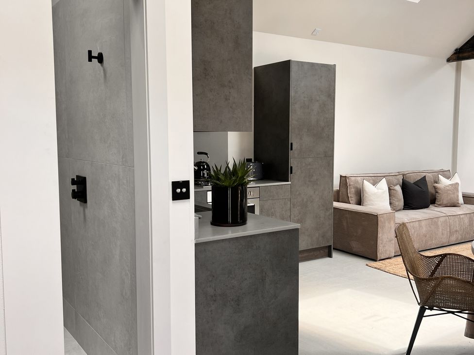 A living space with kitchen cabinet and sofa at Sabi in Gembling near Beeford