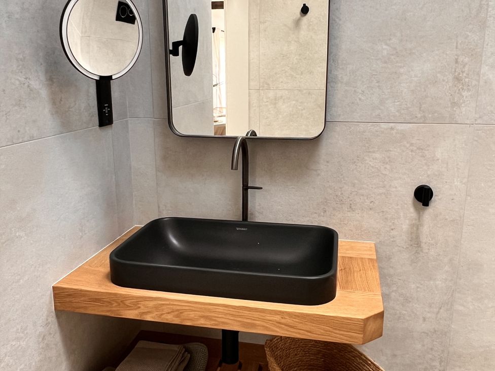 A bathroom with a black sink and mirror at Sabi in Gembling near Beeford