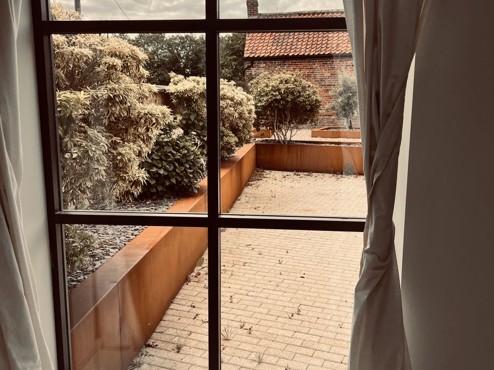 A view from a window showing a garden area at Sabi in Gembling near Beeford