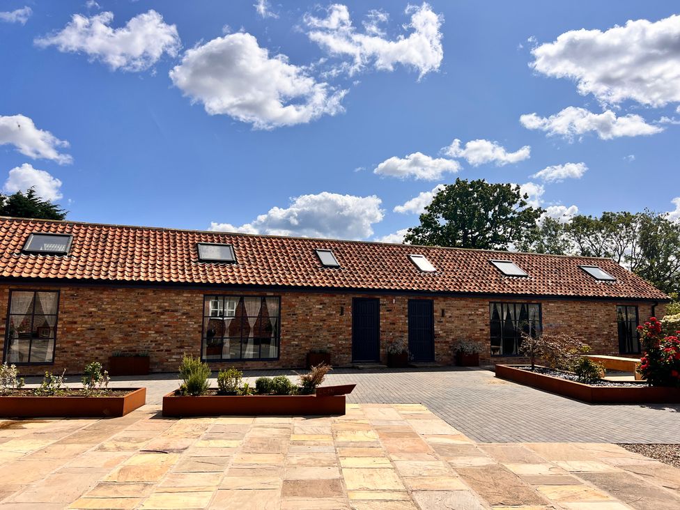 A building with a roof and windows surrounded by a garden at Sabi in Gembling near Beeford