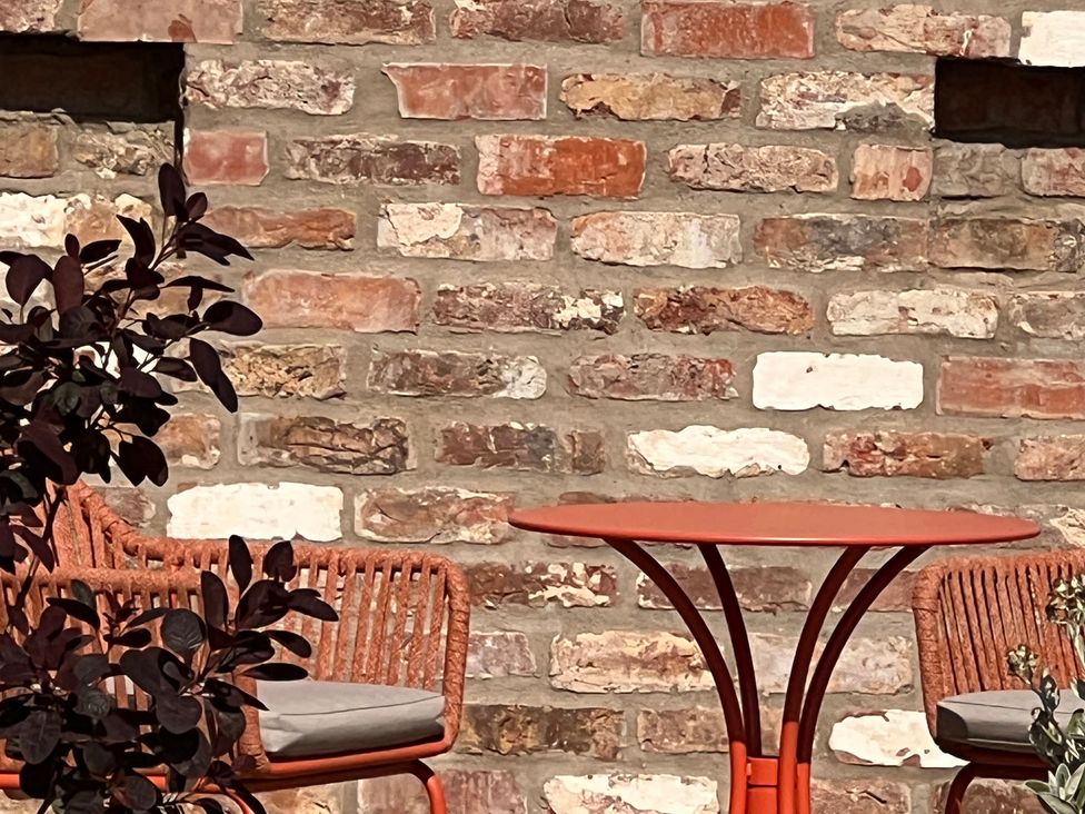 An outdoor seating area with a table and chairs at Sabi in Gembling near Beeford