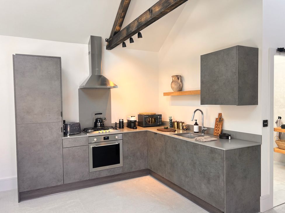 A kitchen with cabinets and appliances at Sabi in Gembling near Beeford