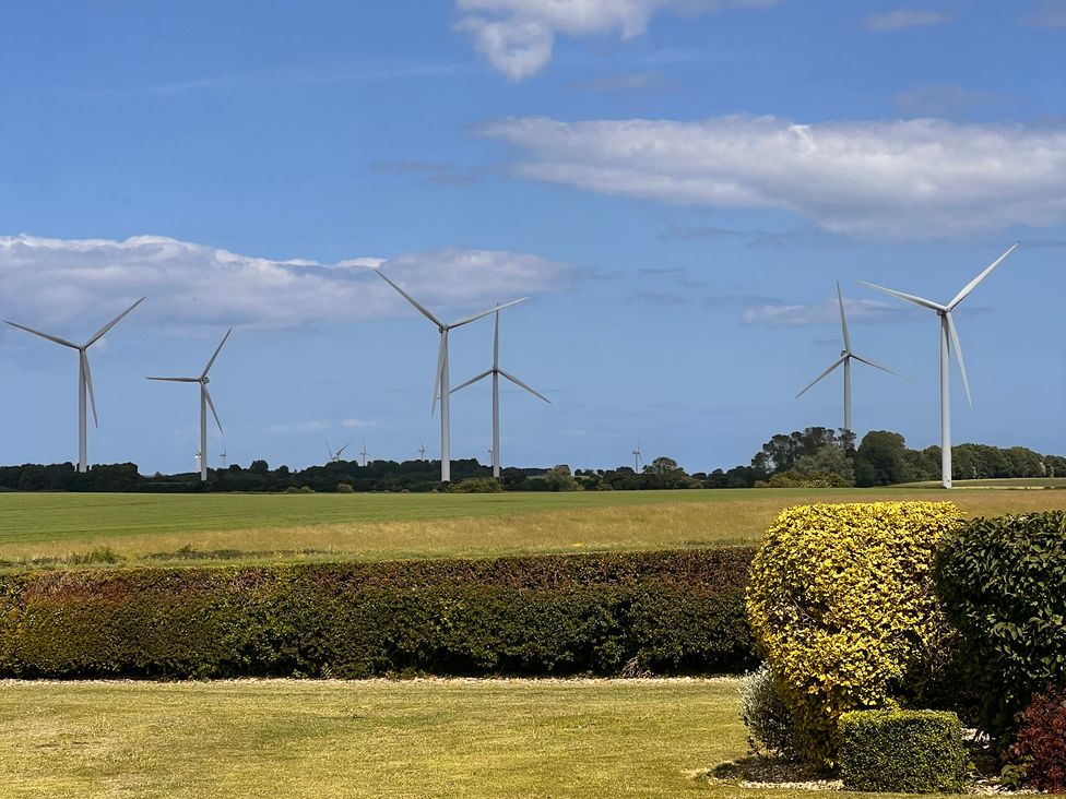 A landscape with wind turbines in a field at Sabi in Gembling near Beeford