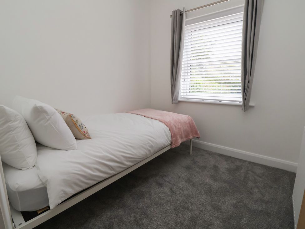 A bedroom with a single bed and window at 5 Marsh Lane, Flint