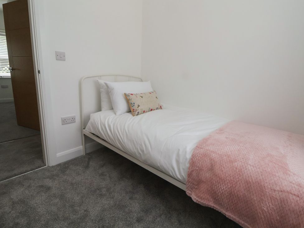 A bedroom with a bed and pillow at 5 Marsh Lane, Flint