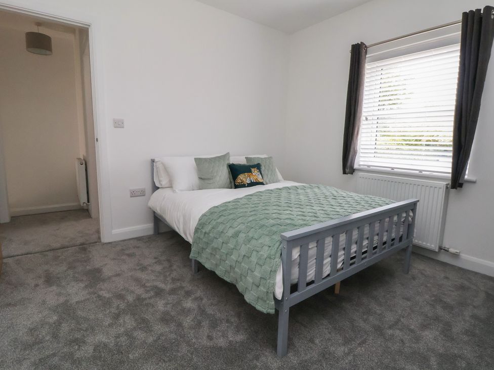A bedroom with a bed and a window at 5 Marsh Lane in Flint