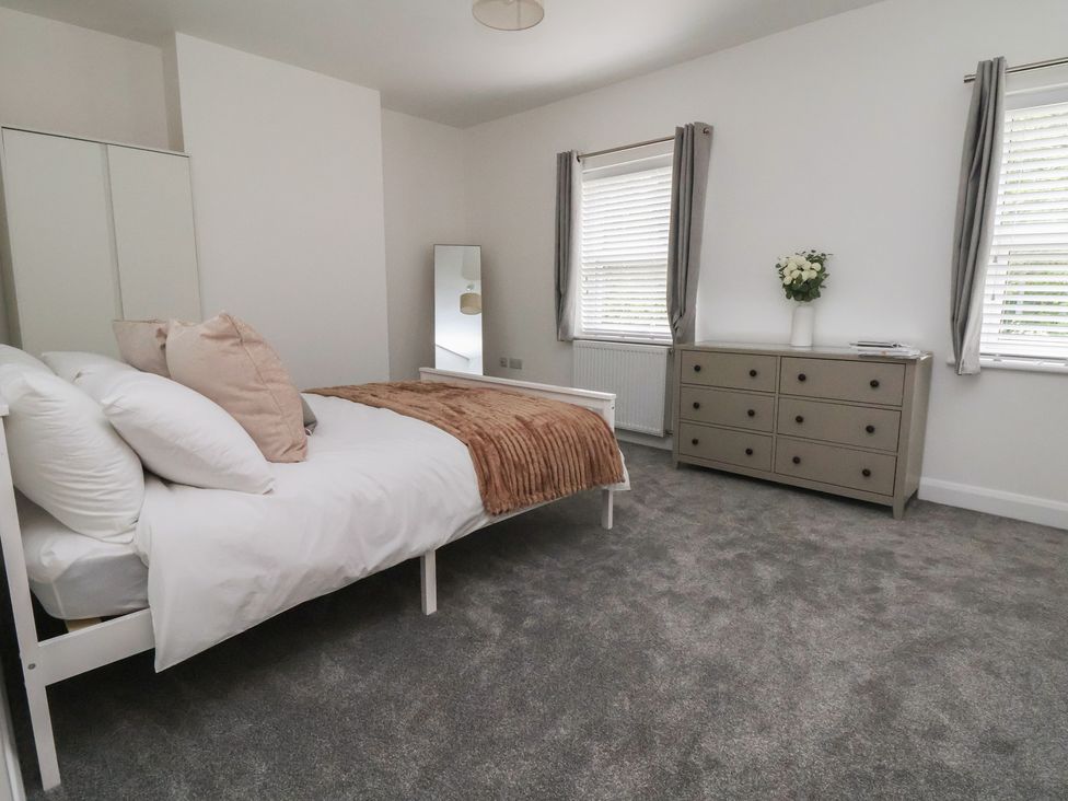 A bedroom with a bed and dresser at 5 Marsh Lane in Flint