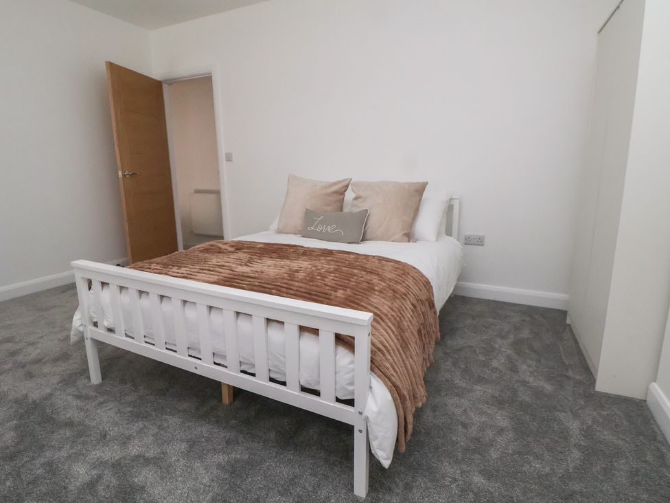 A bedroom with a bed and a door at 5 Marsh Lane Flint