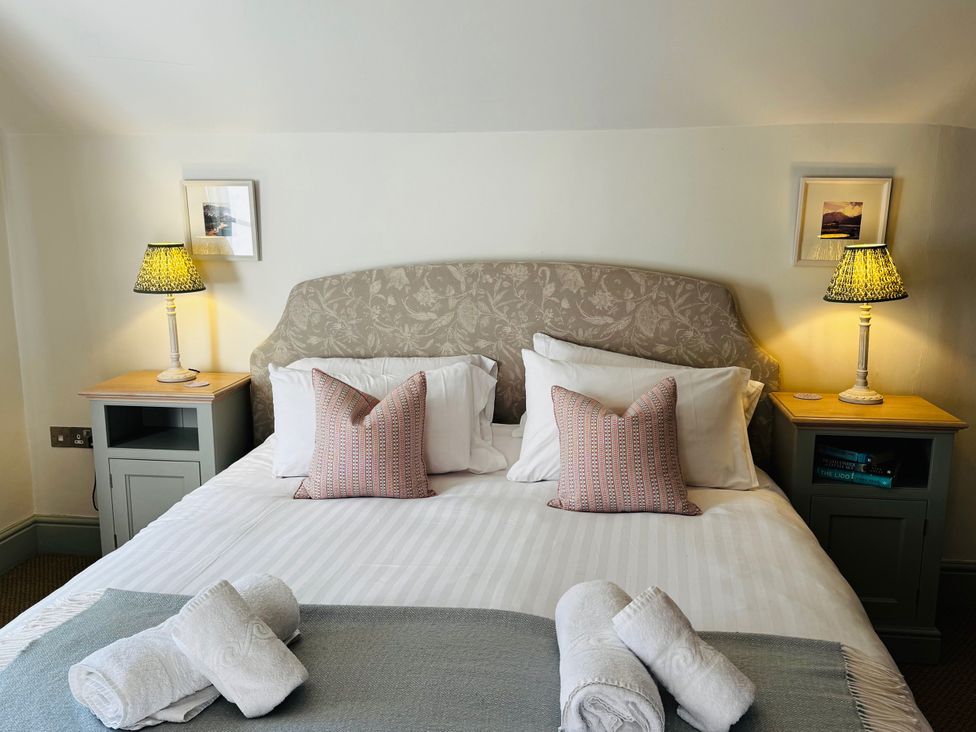 A bedroom with a bed and bedside tables at Stone Arthur Cottage in Grasmere
