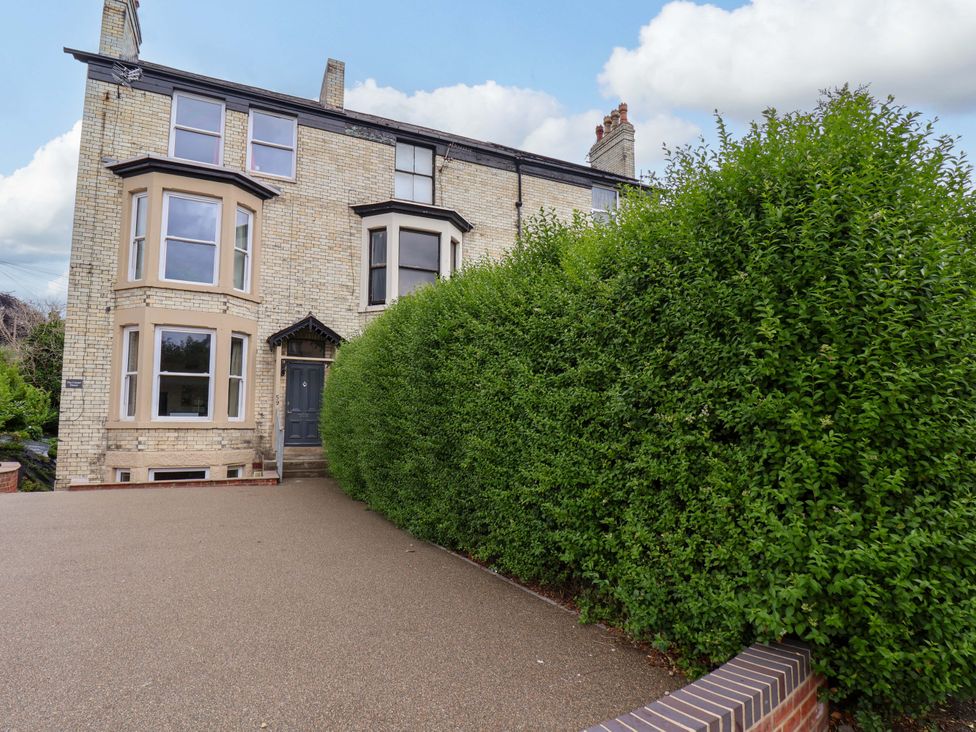A building with a hedge and driveway at The Corner House in Scarborough