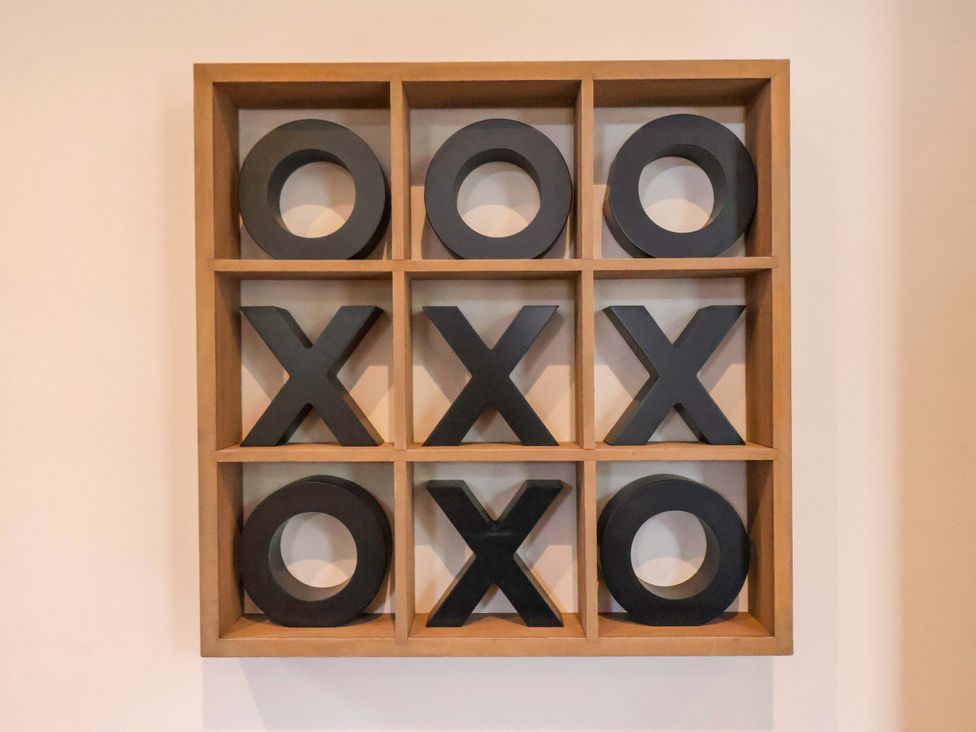 A framed tic-tac-toe game on the wall at The Corner House in Scarborough