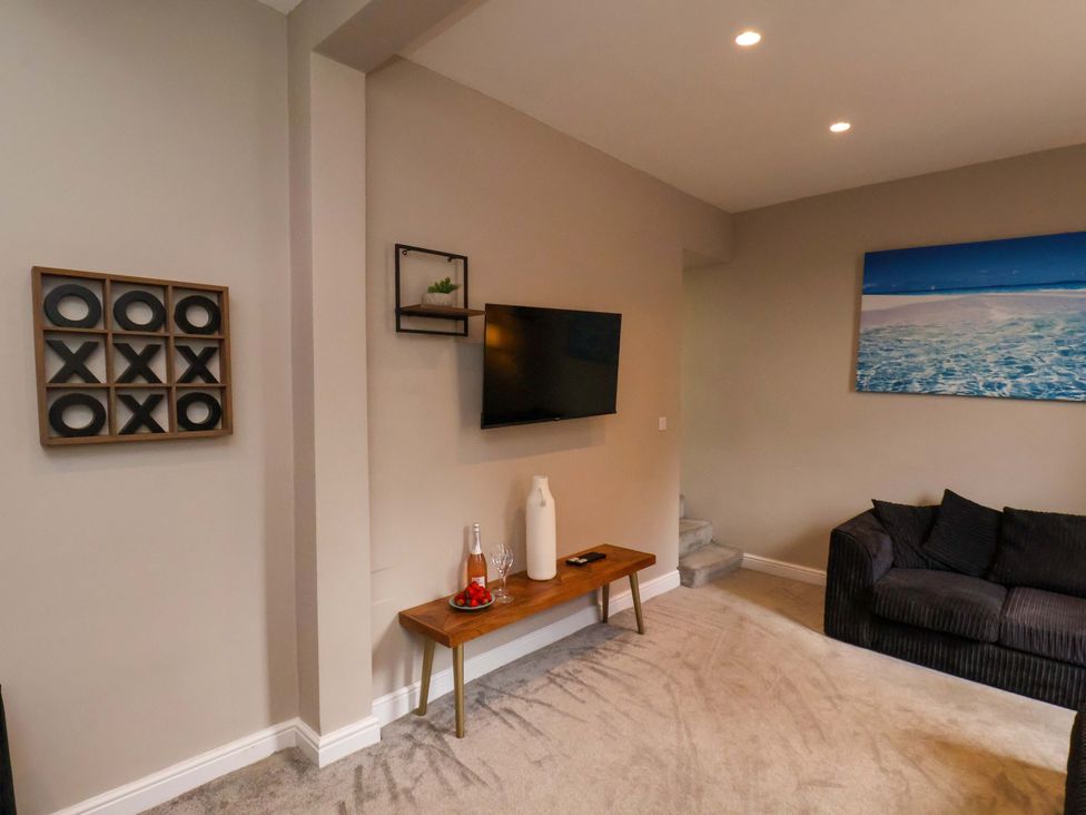 A living room with a television and a console table at The Corner House in Scarborough