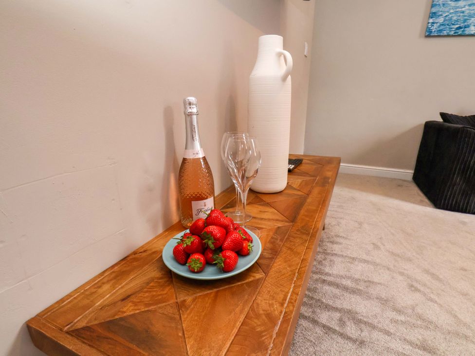A table with a wine bottle, glasses, and strawberries at The Corner House in Scarborough