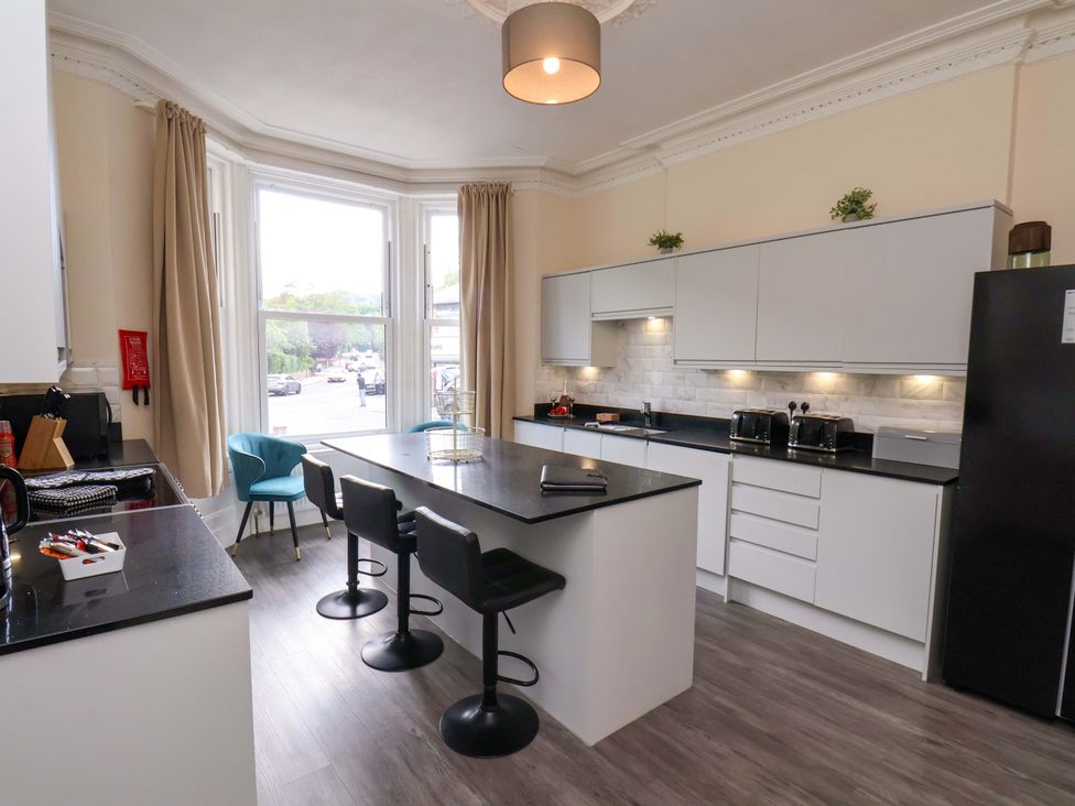 A kitchen with a sink and kitchen island at The Corner House in Scarborough