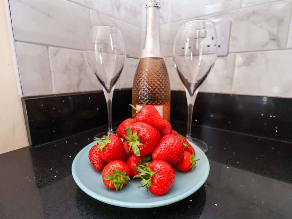A plate of strawberries with a champagne bottle and wine glasses at The Corner House in Scarborough