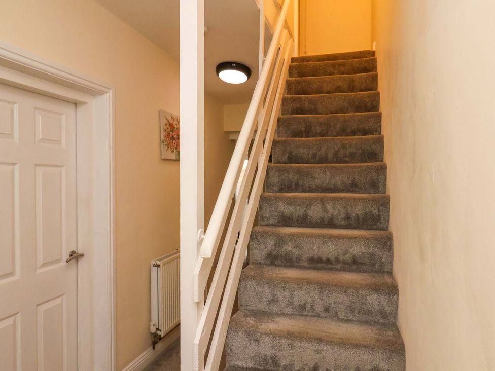 A staircase leading to upper floor in the hallway at The Corner House in Scarborough