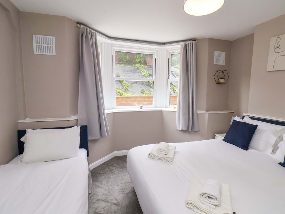 A bedroom with a double bed and a single bed at The Corner House in Scarborough