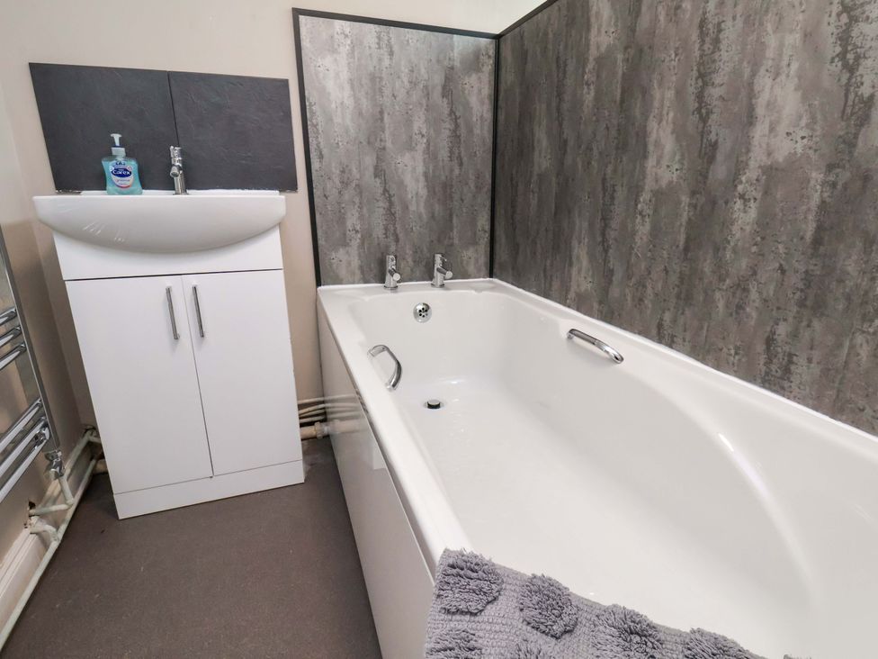 A bathroom with a bathtub and a sink at The Corner House in Scarborough