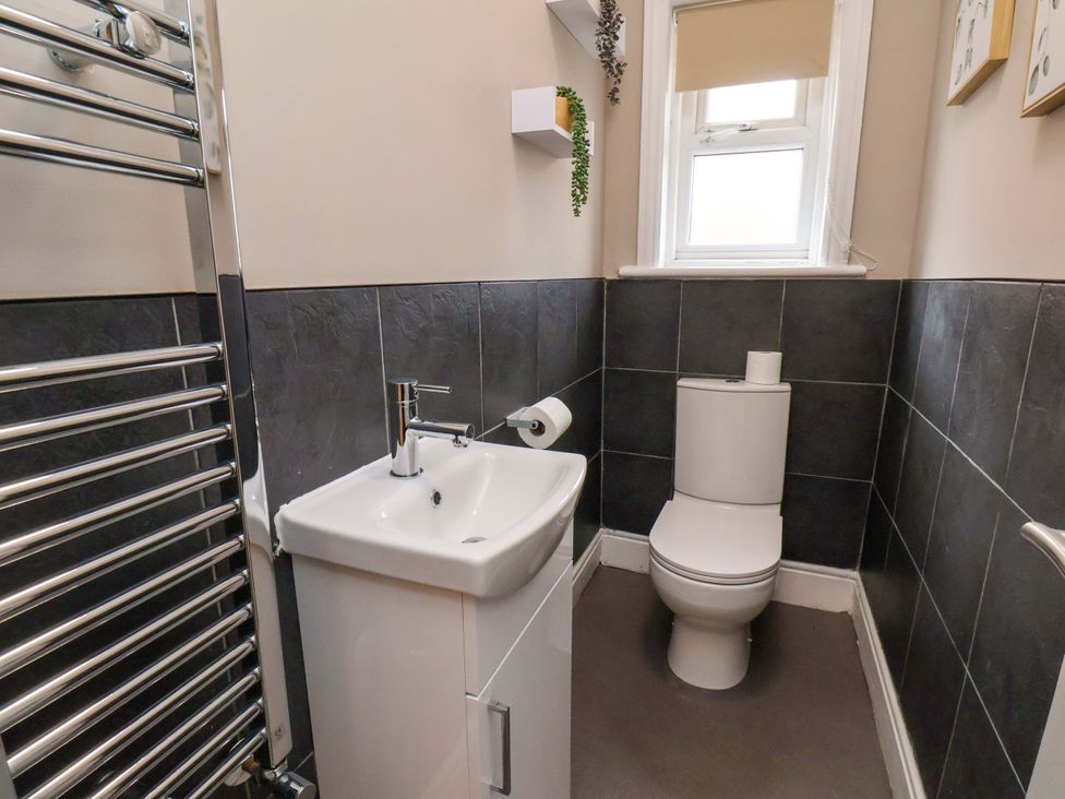 A bathroom with a sink and toilet at The Corner House in Scarborough