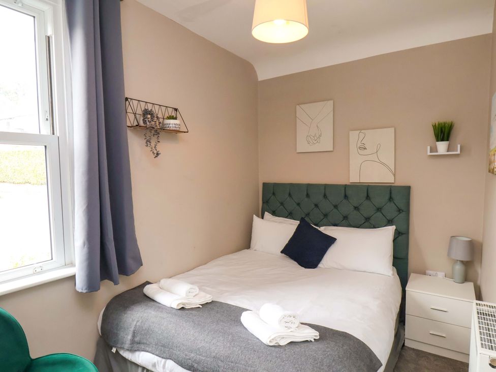 A bedroom with a bed and bedside table at The Corner House in Scarborough