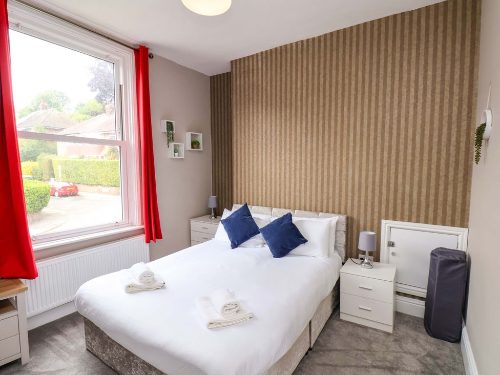 A bedroom with a bed and bedside table at The Corner House in Scarborough