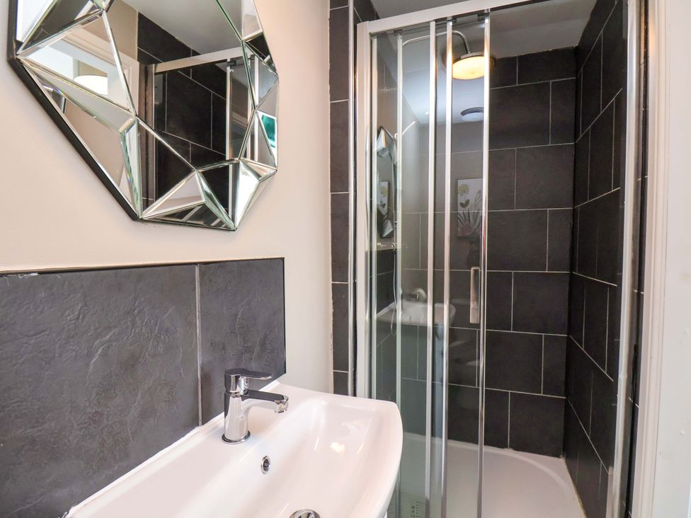 A bathroom with a sink and a shower at The Corner House in Scarborough
