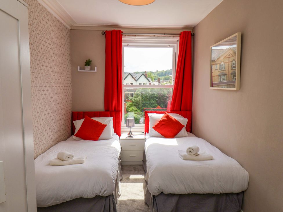 A bedroom with two beds and a window at The Corner House in Scarborough