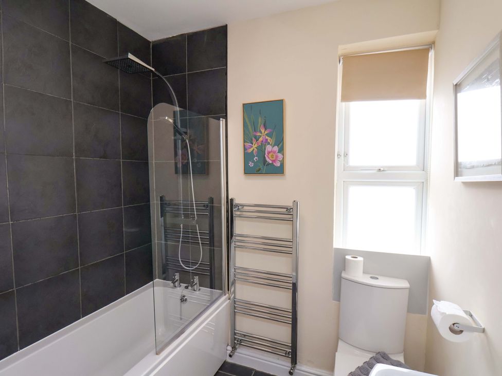 A bathroom featuring a bathtub, toilet, and shower at The Corner House in Scarborough
