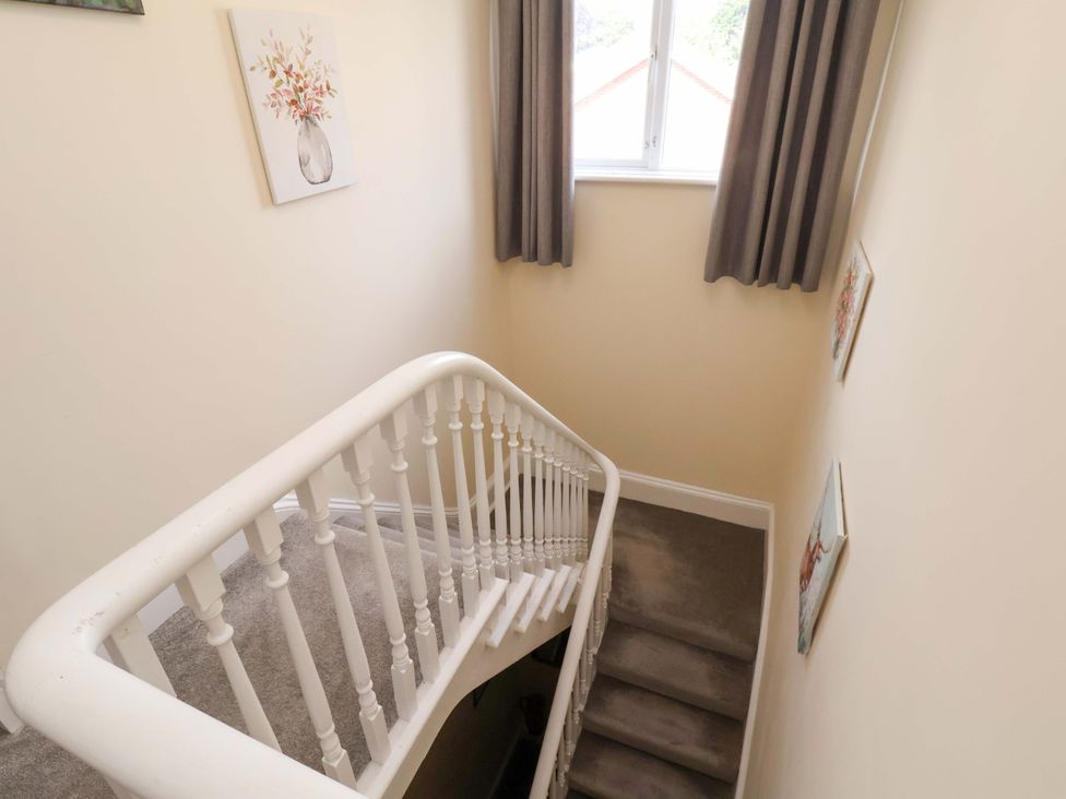 A staircase with wall art and a window at The Corner House in Scarborough