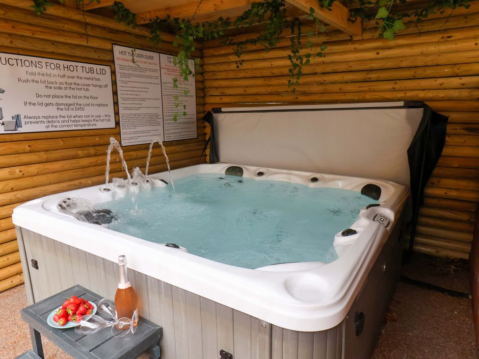 A hot tub with a bottle of champagne and strawberries at The Corner House in Scarborough