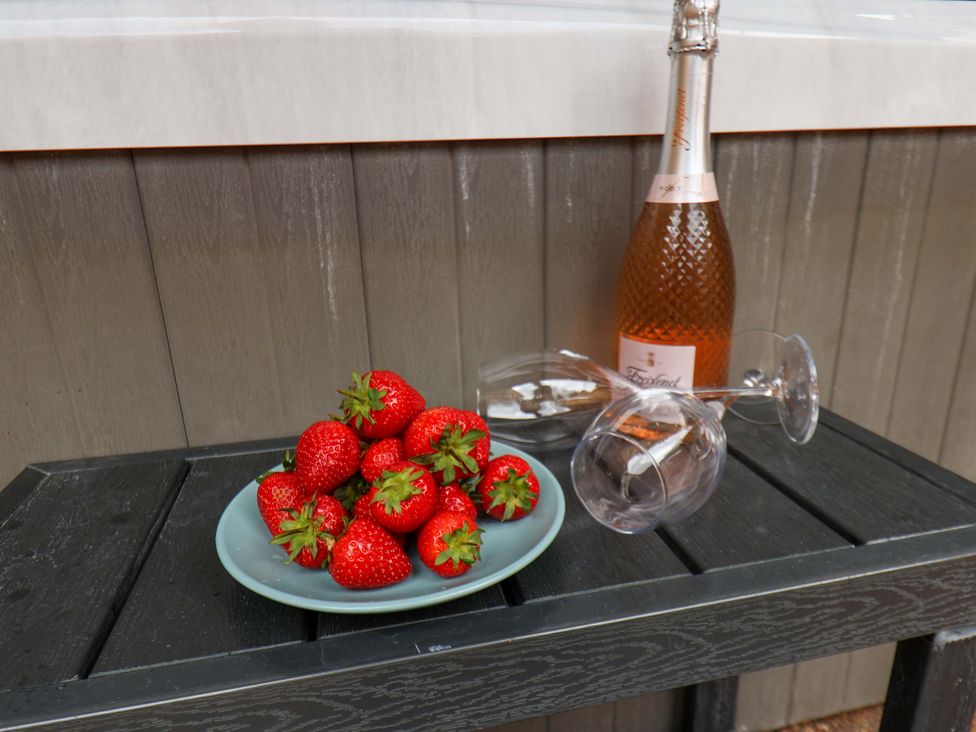 A table with strawberries, a wine bottle and glasses at The Corner House in Scarborough