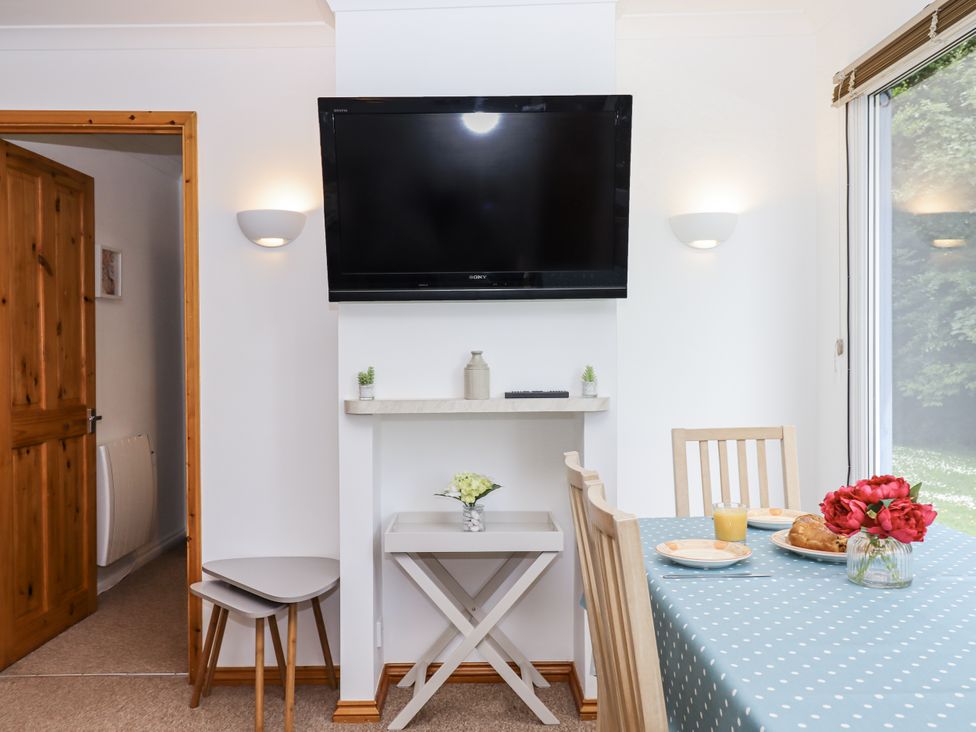 A dining room with a table and chairs at Driftwood, Dartmouth