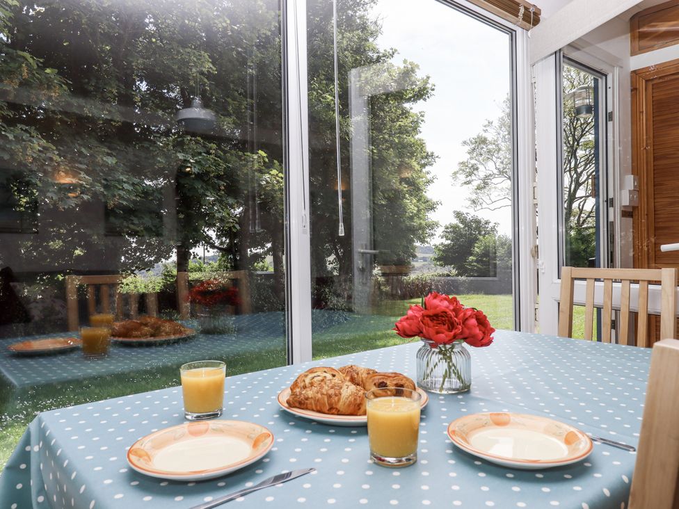 A dining room with a table set for breakfast at Driftwood Dartmouth