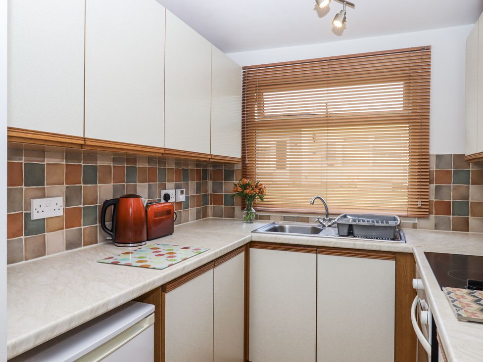A kitchen with a sink and kettle at Driftwood Dartmouth