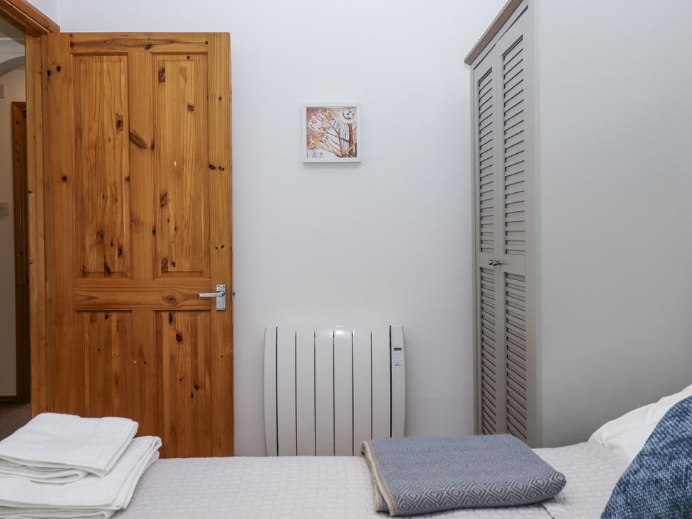 A bedroom with a door and a wall heater at Driftwood in Dartmouth