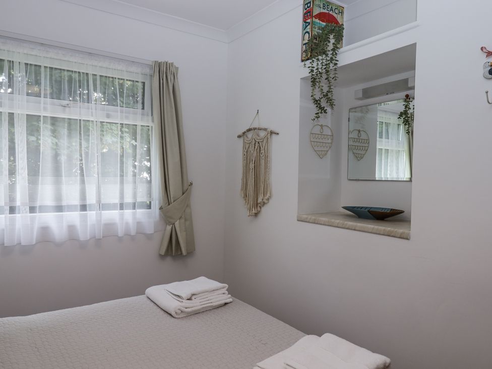A bedroom with a bed and decorative items at Driftwood in Dartmouth