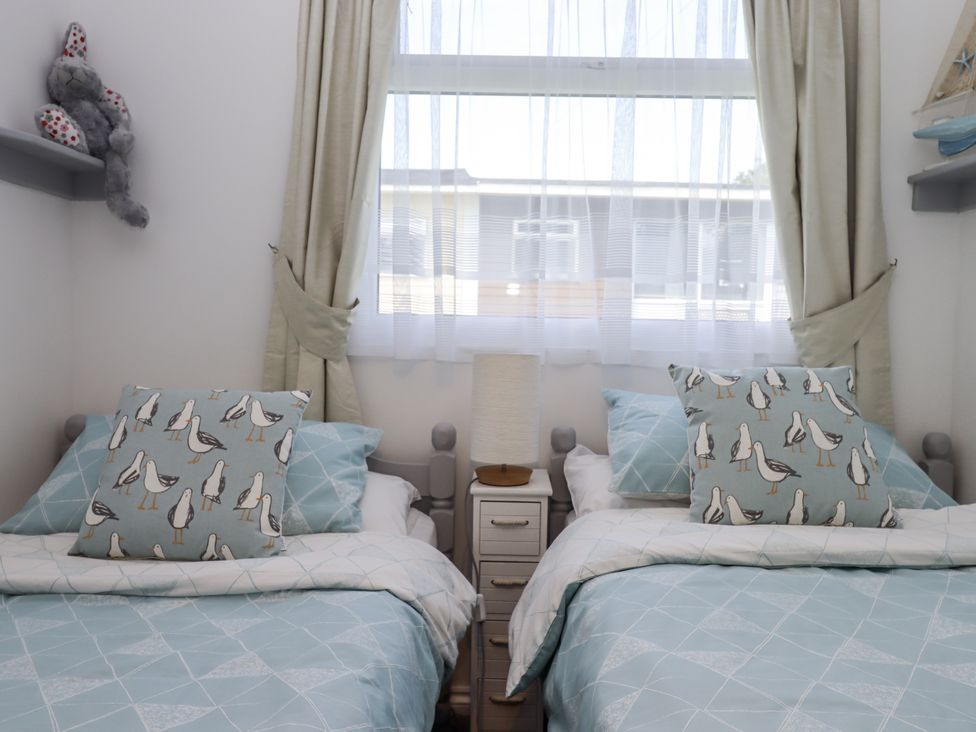 A bedroom with two beds and a lamp at Driftwood in Dartmouth