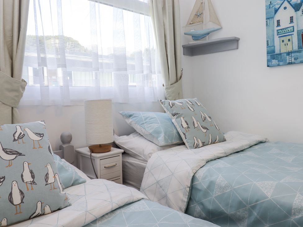 A bedroom with two beds and a nightstand at Driftwood in Dartmouth