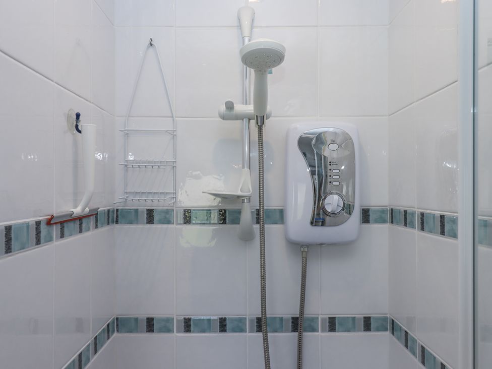 A shower with controls and hose in the bathroom at Driftwood Dartmouth