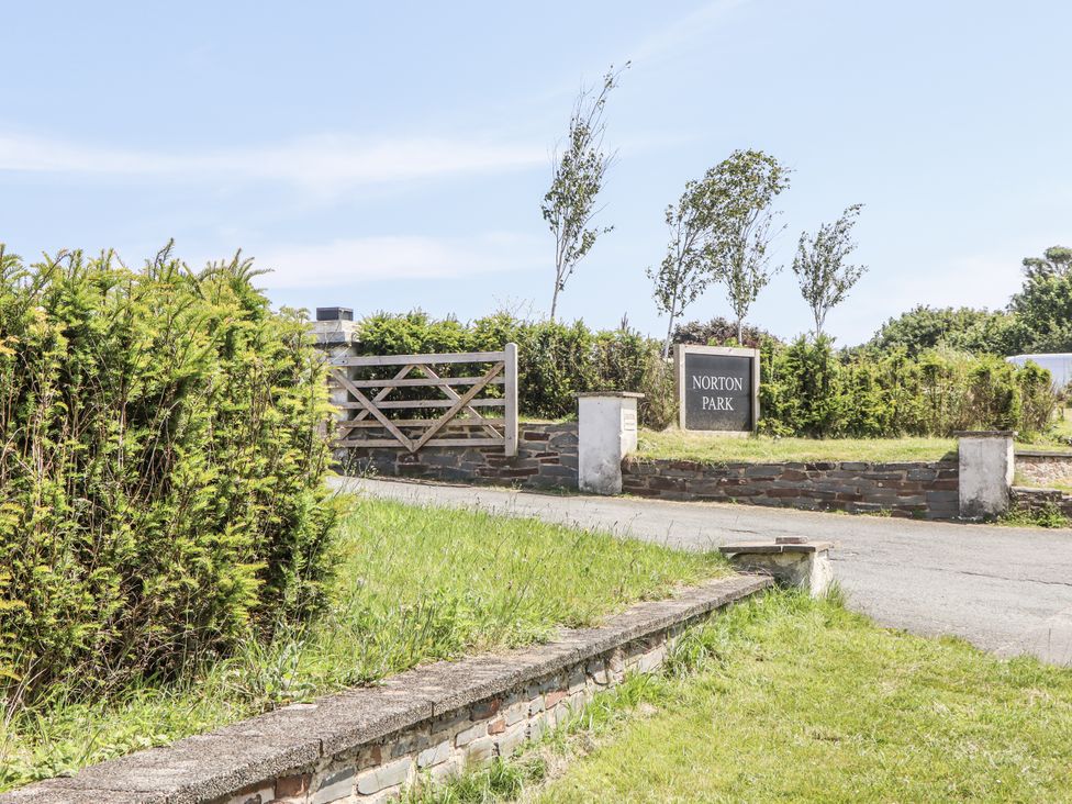 An entrance with a gate and sign at Norton Park in Dartmouth