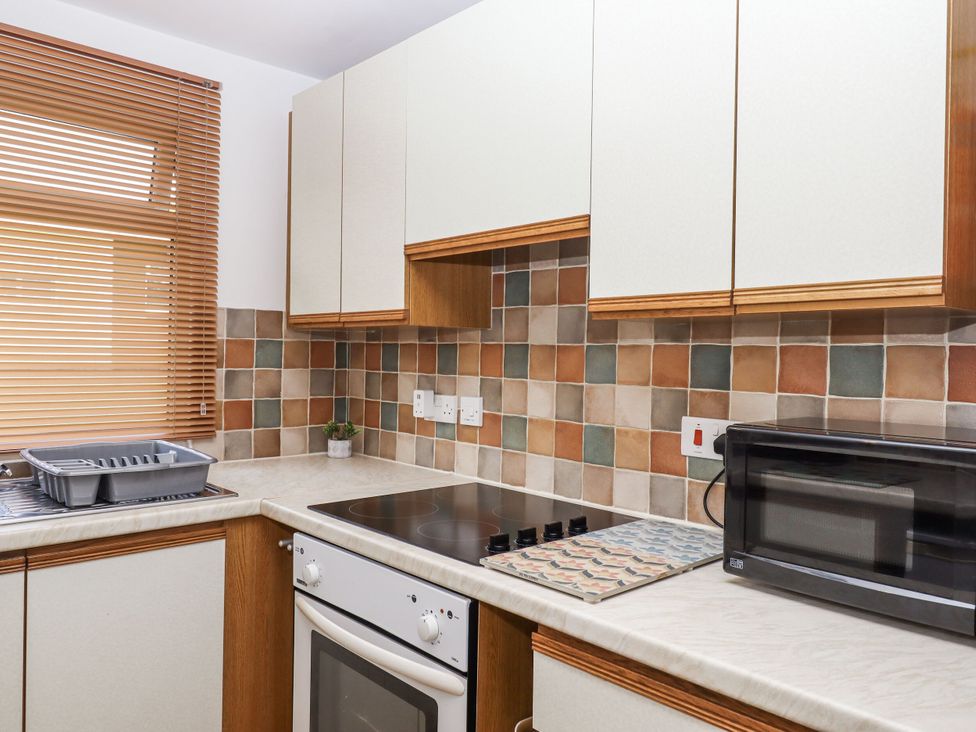 A kitchen with a stove and microwave at Driftwood in Dartmouth