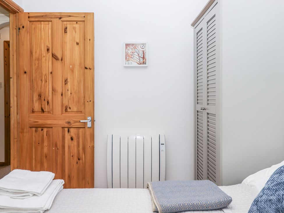 A bedroom with a radiator and wardrobe at Driftwood in Dartmouth