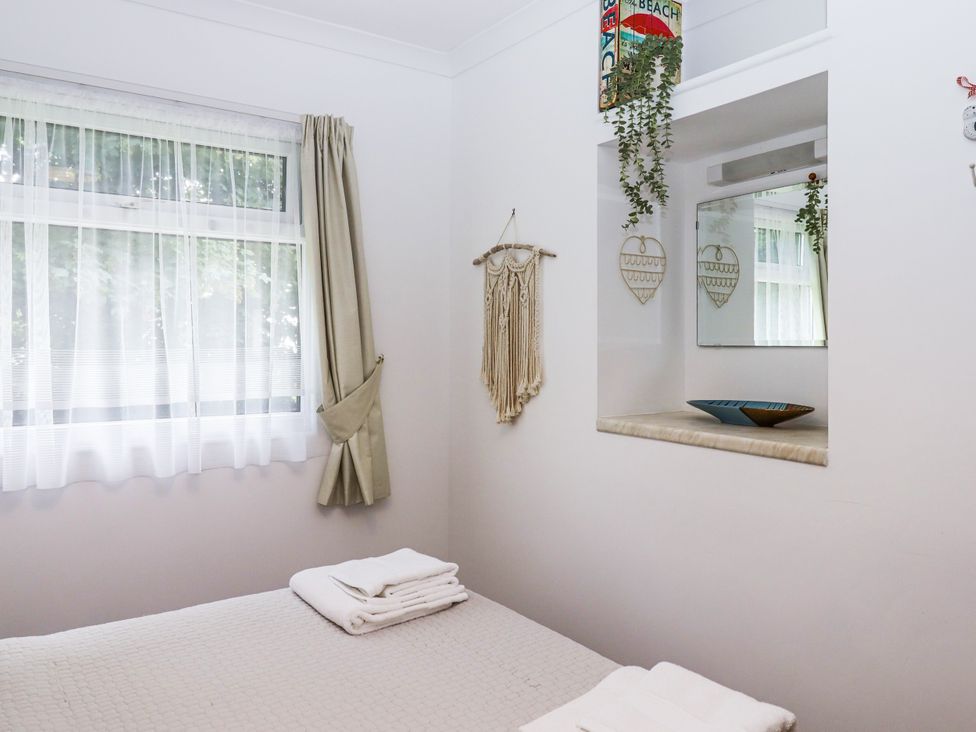 A bedroom with a bed and window at Driftwood in Dartmouth